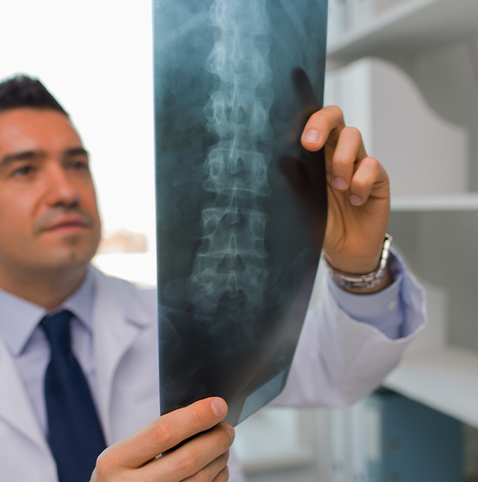 Doctor at Dynamic Chiropractic examining patient x-rays for spine injury