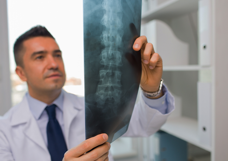 Doctor at Dynamic Chiropractic examining patient x-rays for spine injury